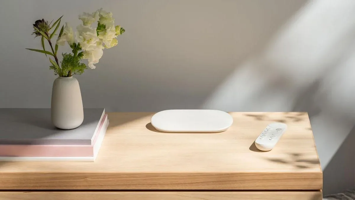 Google TV Streamer and remote on a wooden media console